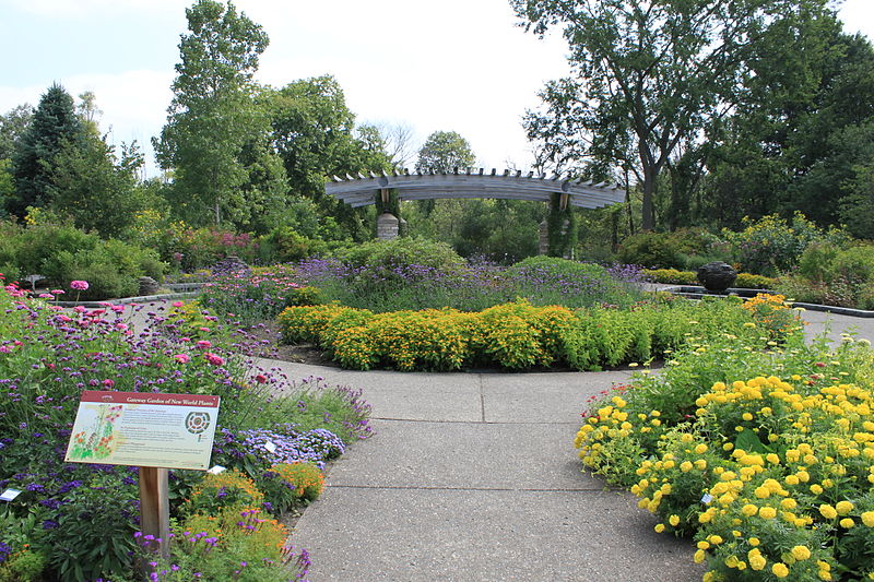 Path with flowers on either side leading to a pavilion with flowers in the center
