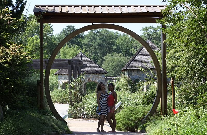 Two women standing beneath a circle entrance