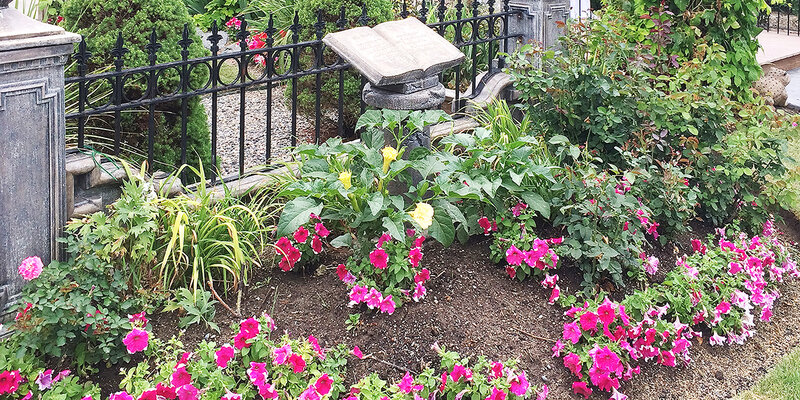 DeWalt Gardens in Billings, Montana, landscaping, flowers and a pedestal with a book open.
