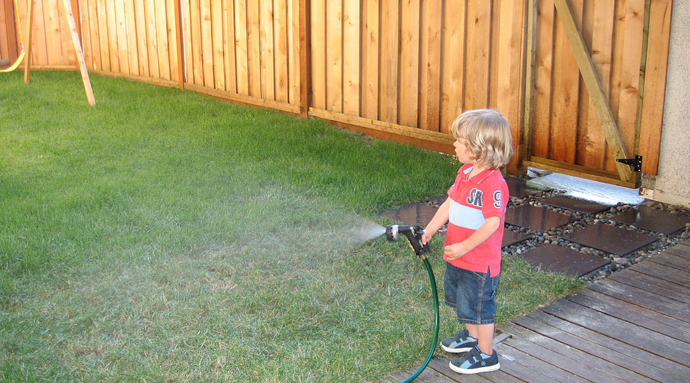 boy watering the lawn