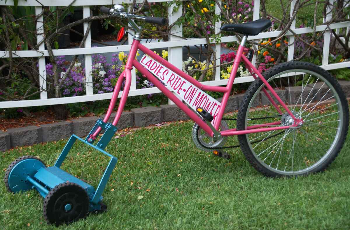 image of a bicycle lawn mower on a grass