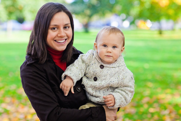 Mom holding her baby and smiling