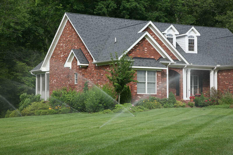 image of a lawn irrigation system in front of a house