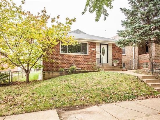 House with a lawn with fallen leaves on it