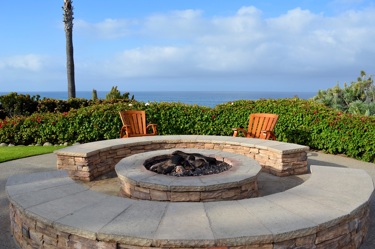 Fire pit with two chairs overlooking water