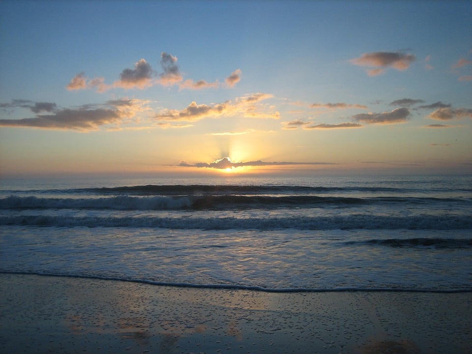 sun setting on a beach