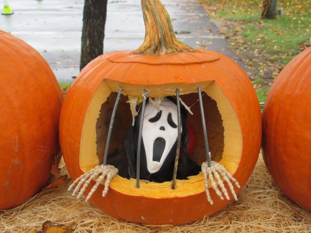 Carved pumpkin with specter inside.