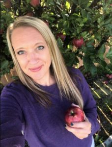 Amanda Shiffler with an apple from her backyard tree