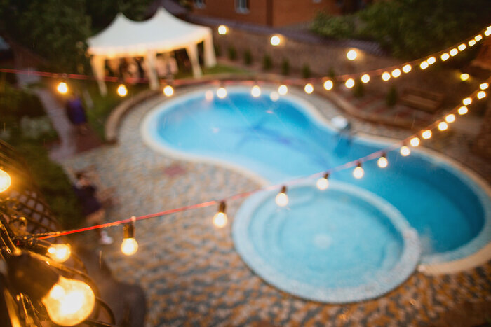 Garland light suspended over a swimming pool. 