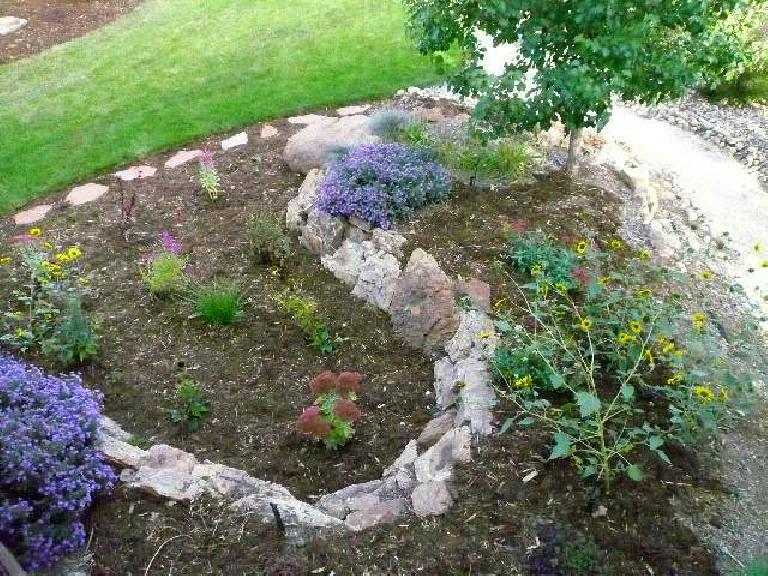 A xeriscape next to a small lawn