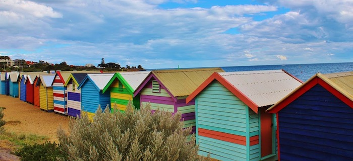 Colorful beach huts against a sky background