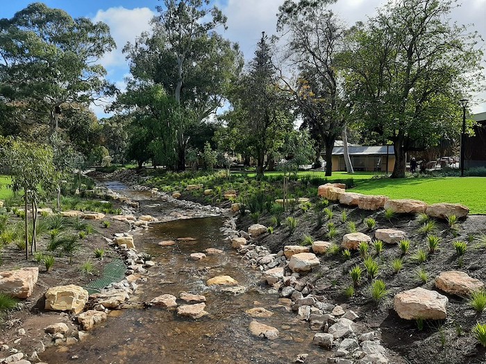 Rippling creek surrounded by stones