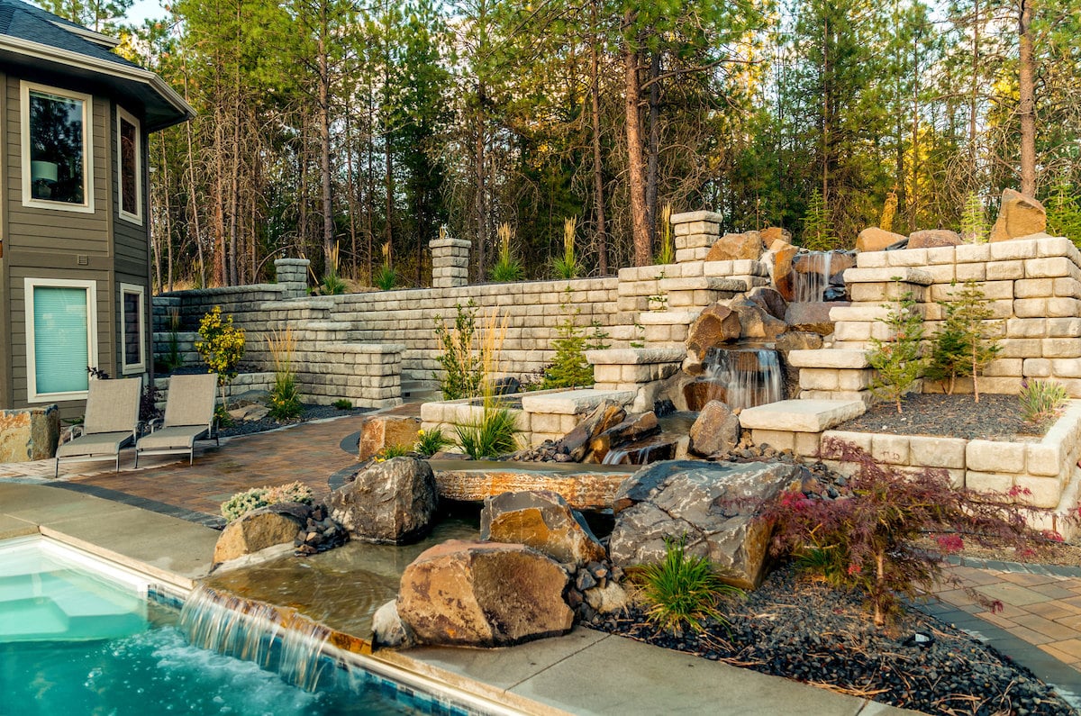 Poolscape with retaining walls and landscaping blocks.