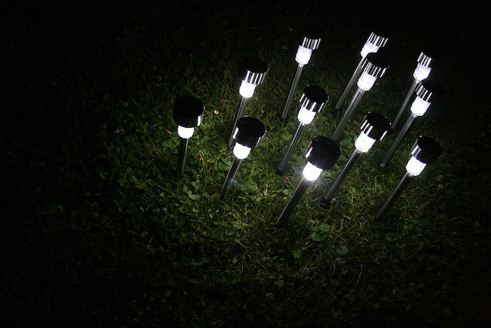 A group of small solar lights embedded in the ground