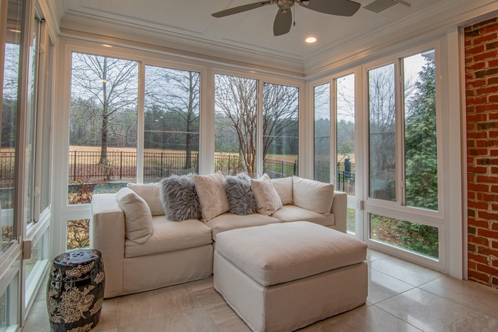 She shed idea featuring a white sofa near glass windows