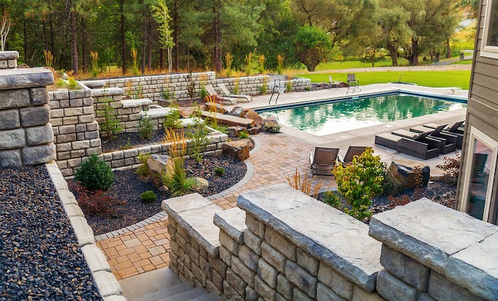 Poolscape with retaining walls and paver patio