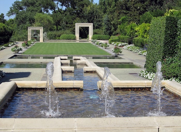 Fountain in formal garden shoots water into the air