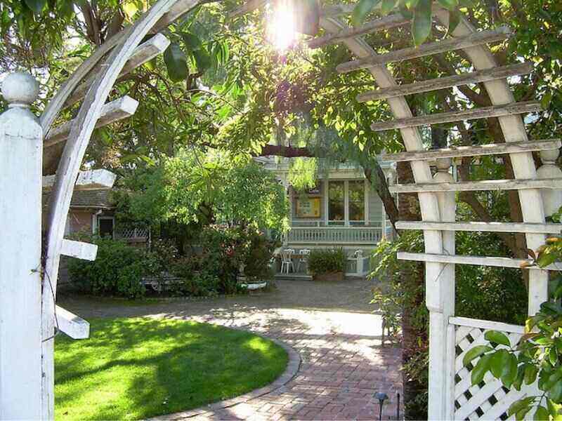 Arched trellis leads to a home's front entryway