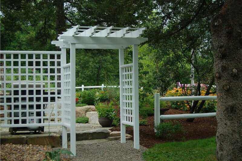 White trellis separates garden from yard