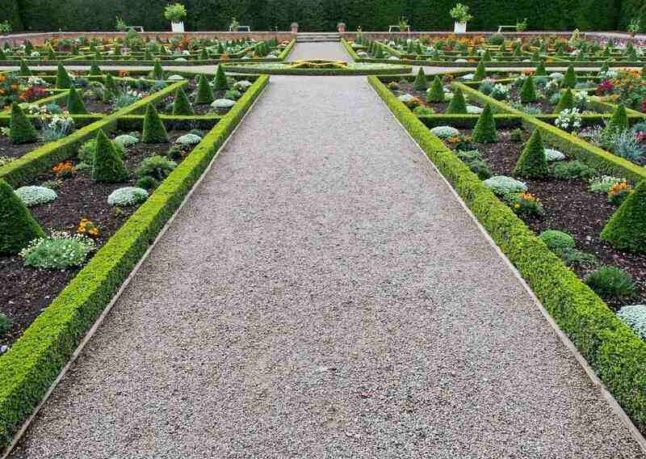 A pea gravel path through a large garden