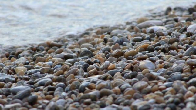 Pea gravel depth of field with water in the background