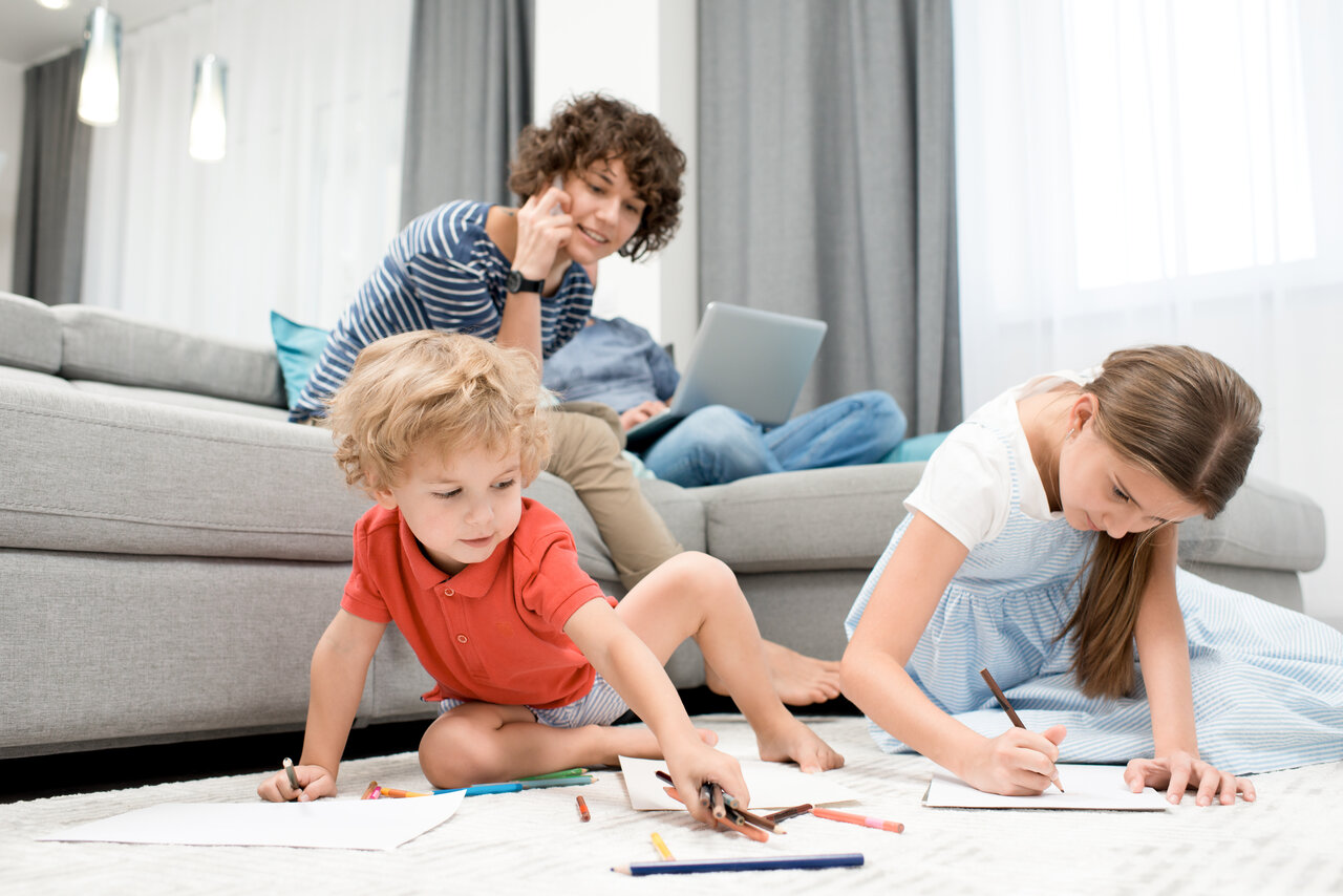 Mom working from home and keeping an eye on her kids