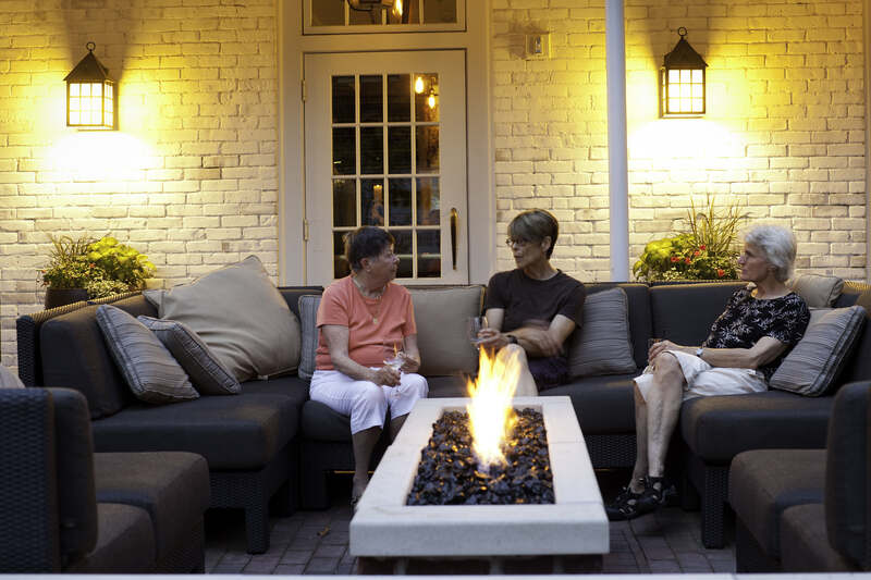 people sitting near a fire pit