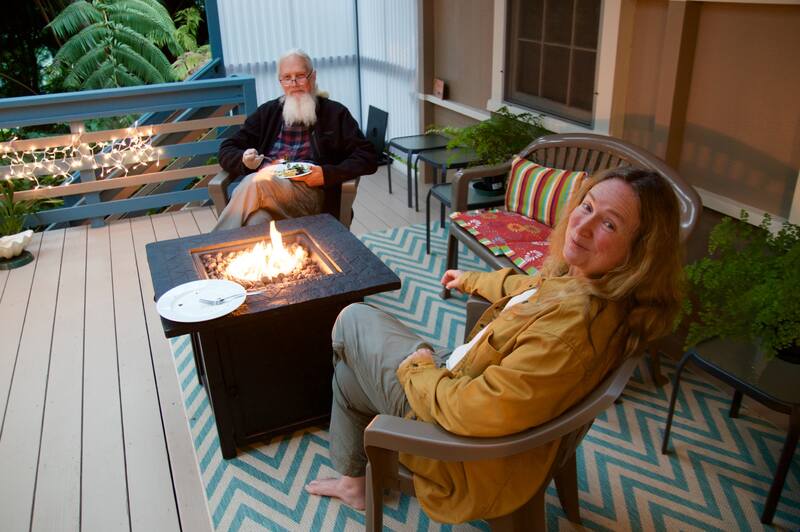 old couple sitting near a fire pit