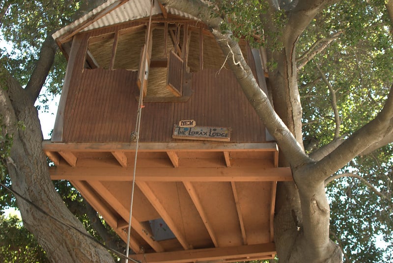 Looking up at a wooden treehouse