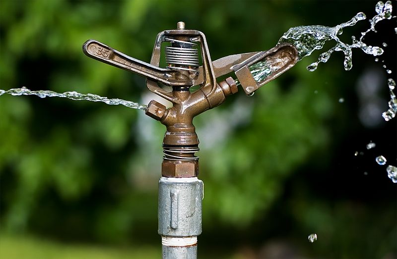 Close up of an impact sprinkler withe water coming out