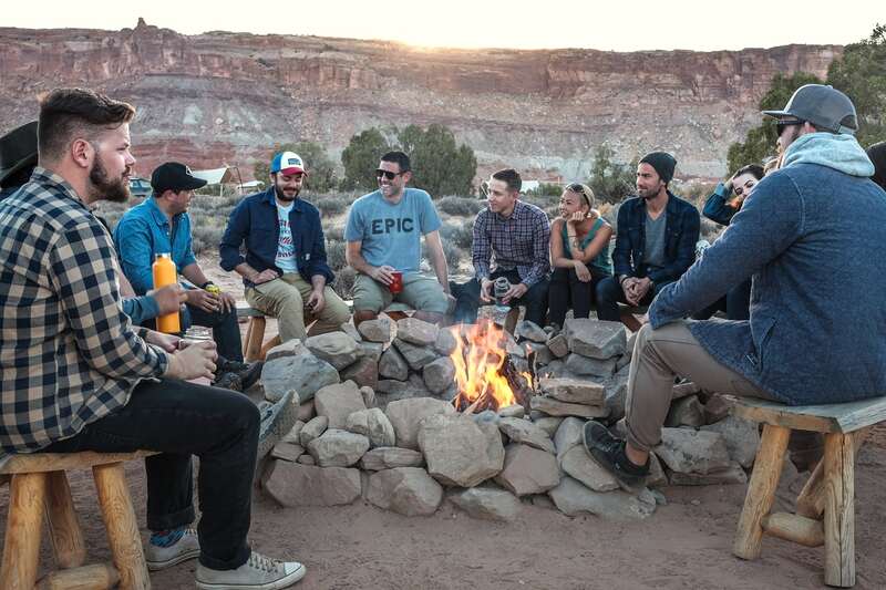 gathering of people near fire pit