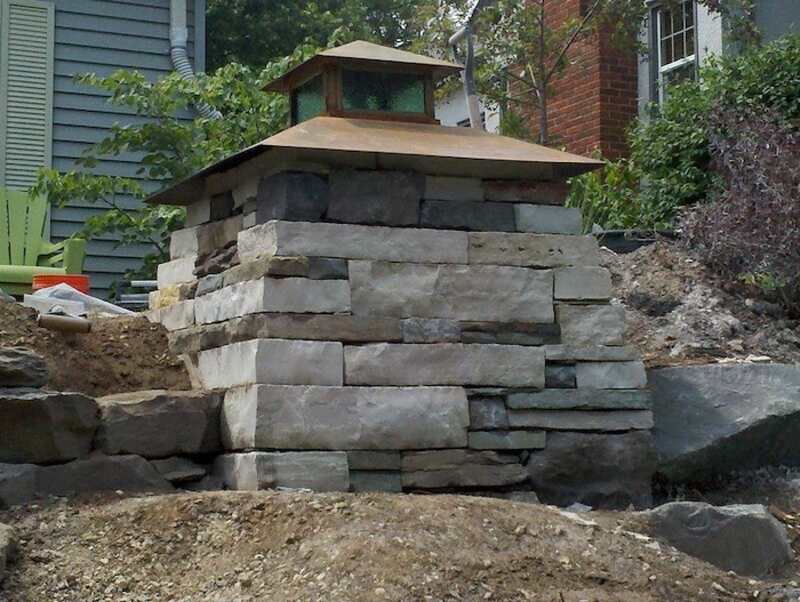 A landscaping block stand supports an outdoor lighting fixture