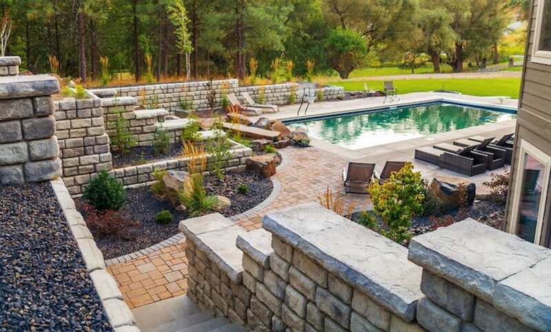 Poolscape with retaining walls and paver patio