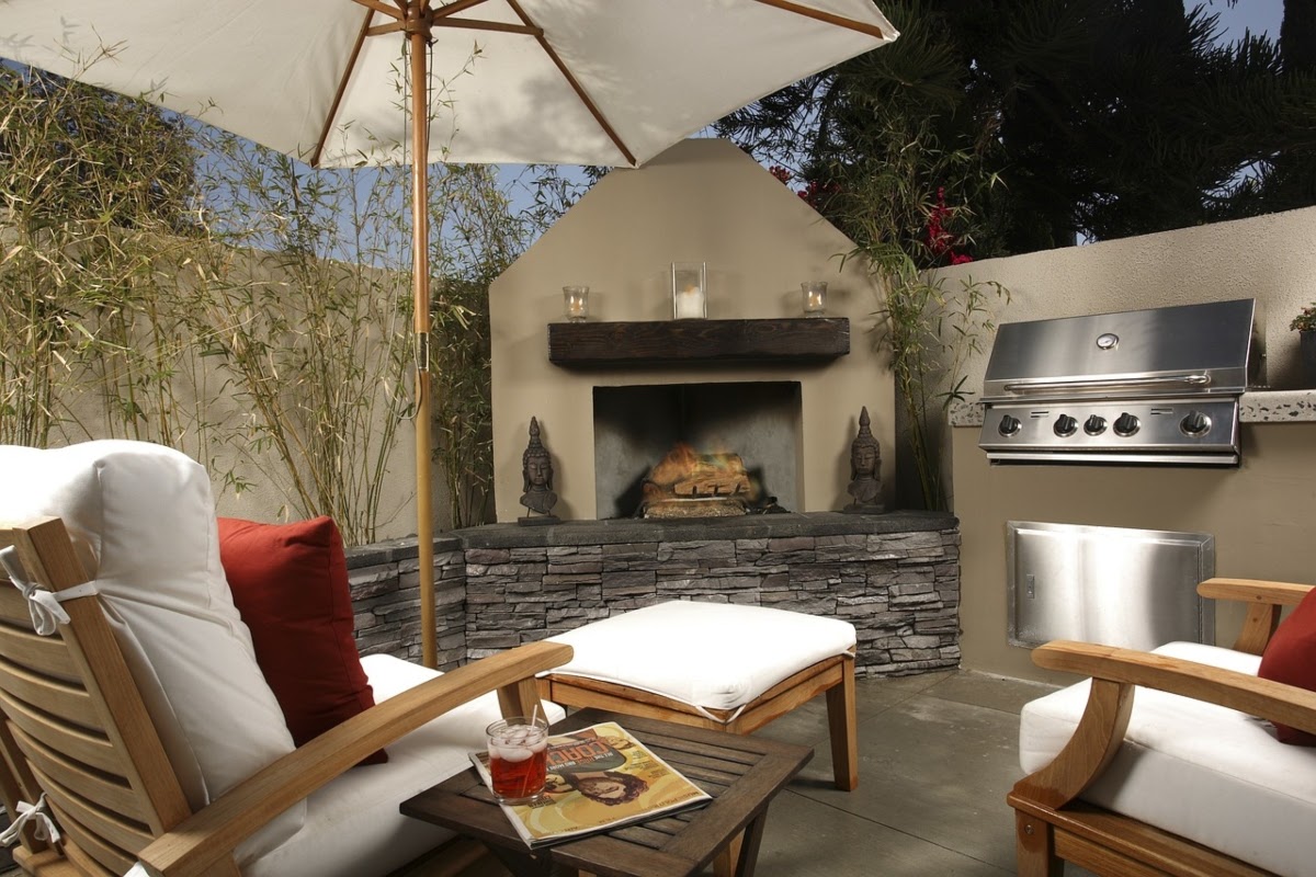Patio with seating, outdoor fireplace, umbrella, and grill