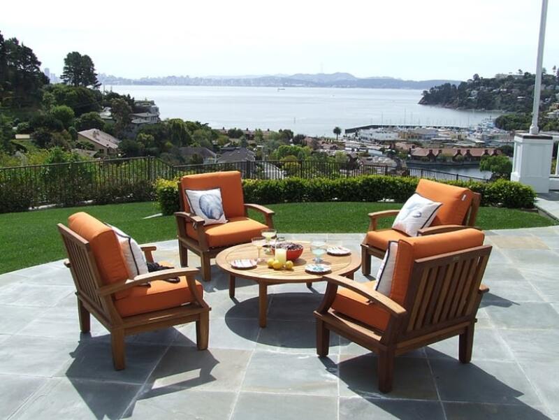 patio with teak furniture and stone flooring