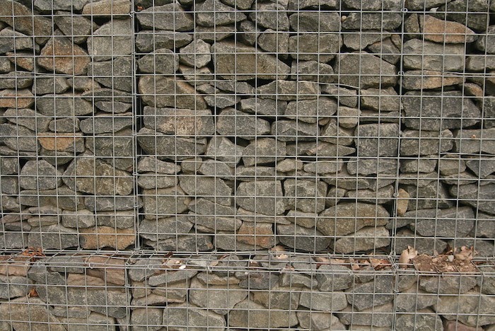 Close up of a gabion basket filled with brown stones