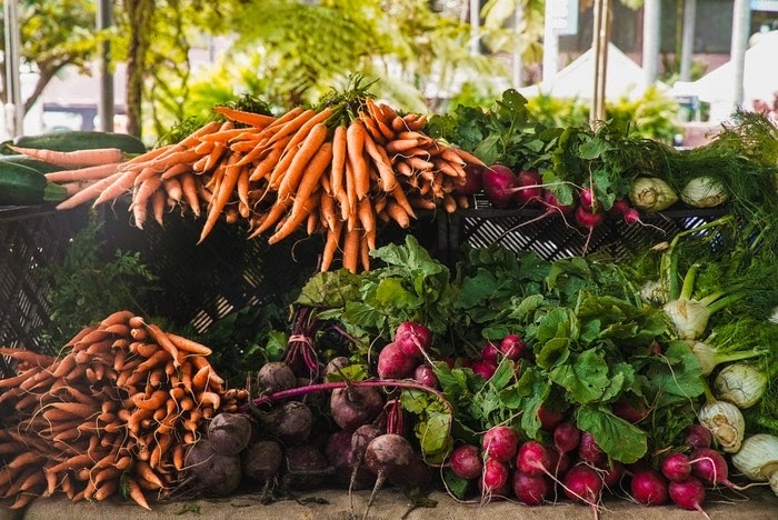 A pile of vegetables, including carrots, radishes, and beets