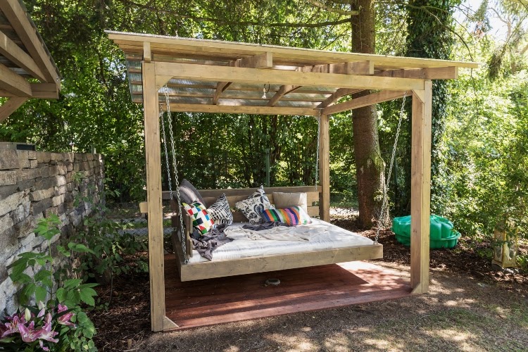 small patio with pergola over daybed swing