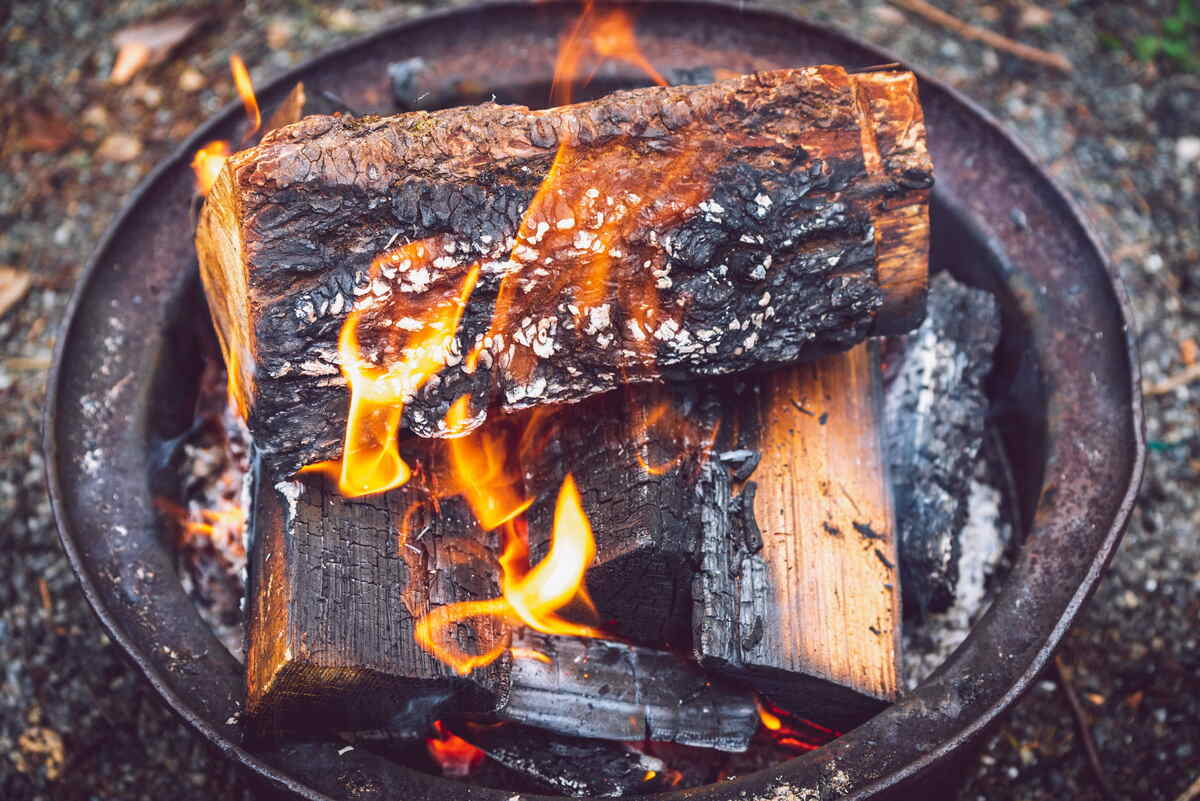 Wood logs burning on a fire pit