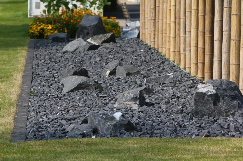 A rock garden of black lava rock with large rocks mixed in with small rocks