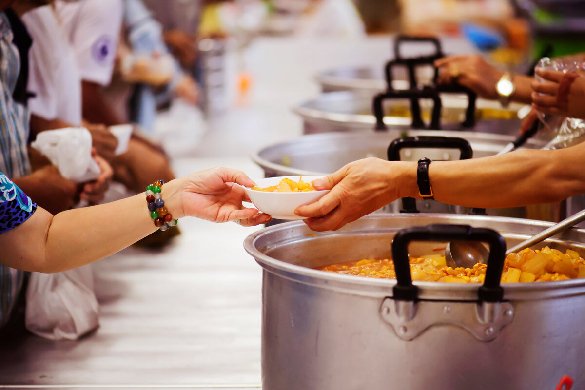 Volunteers feeding the hungry at a soup kitchen