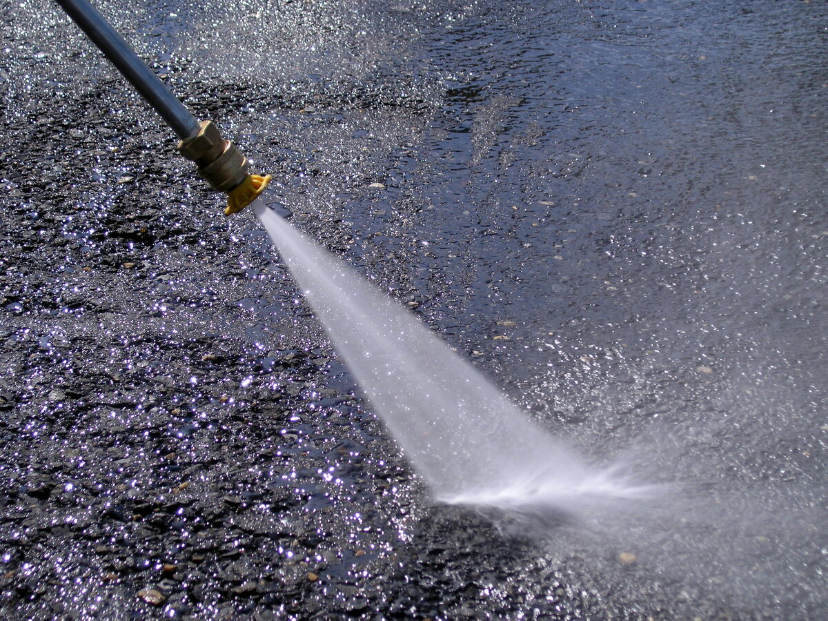Pressure washer being used on concrete