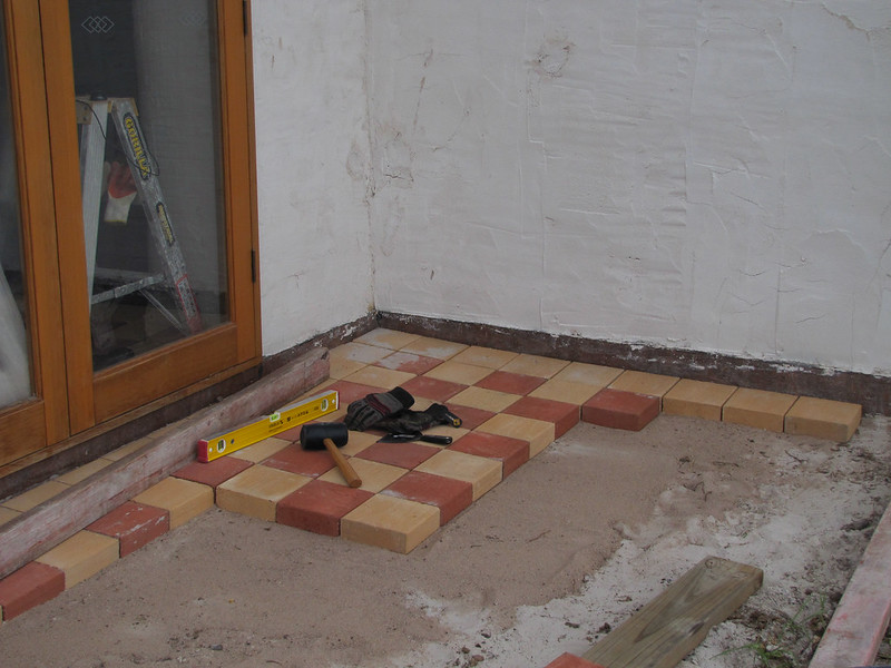 Partially built patio with red and yellow brick