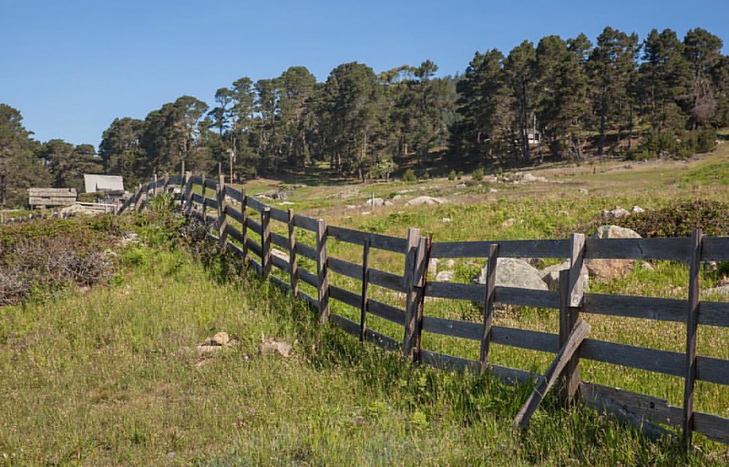 Wooden fence built on a slope in the land