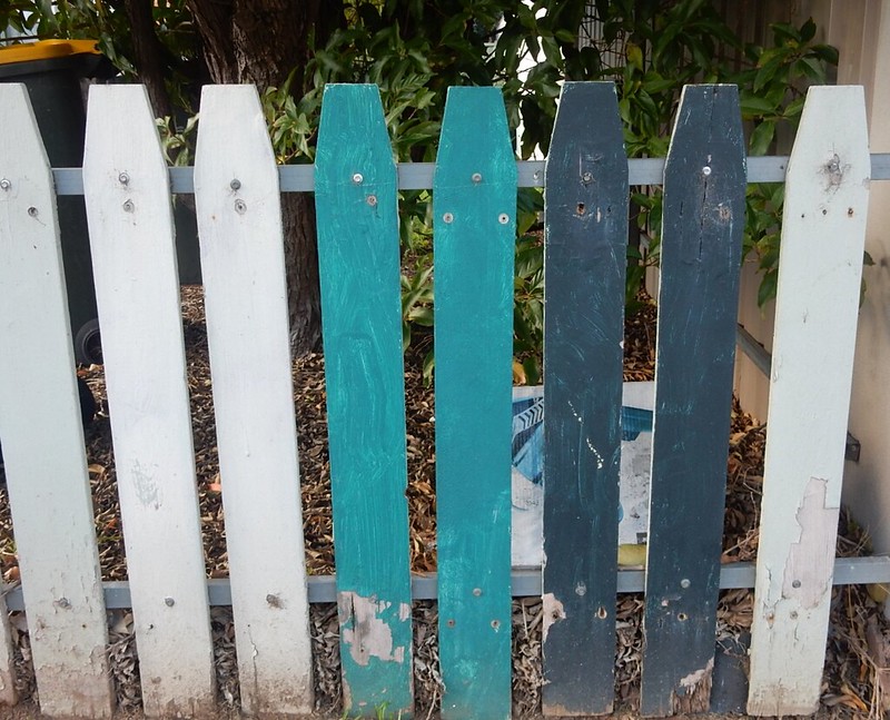 Painted picket fence in blue, teal and white
