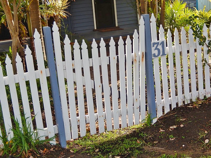 White and blue wood picket fence gate