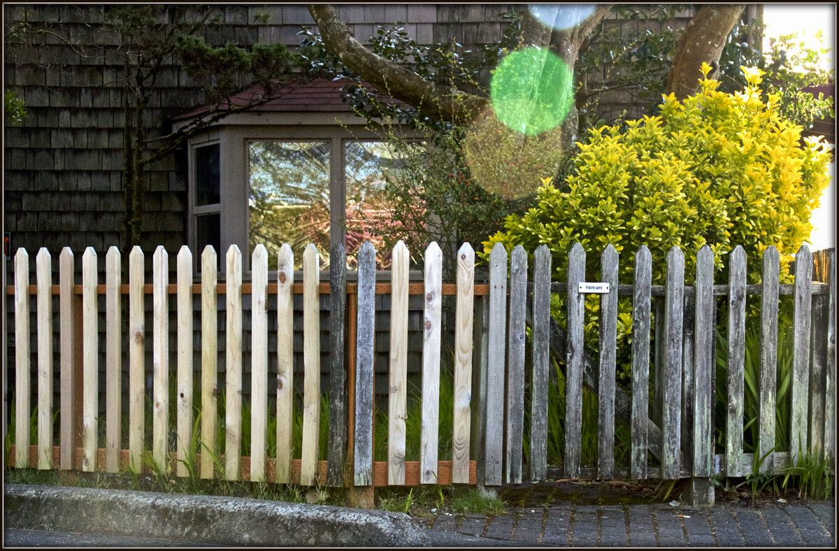 Wood picket fence in front of a house