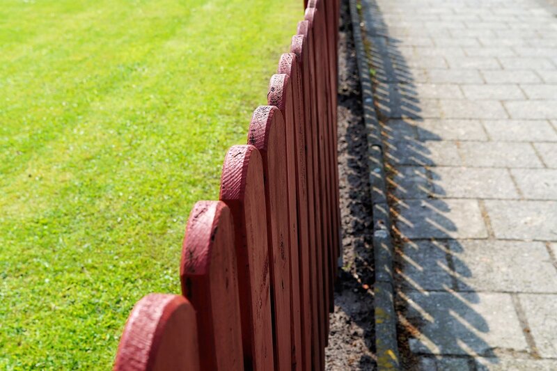 Wooden fence line painted red
