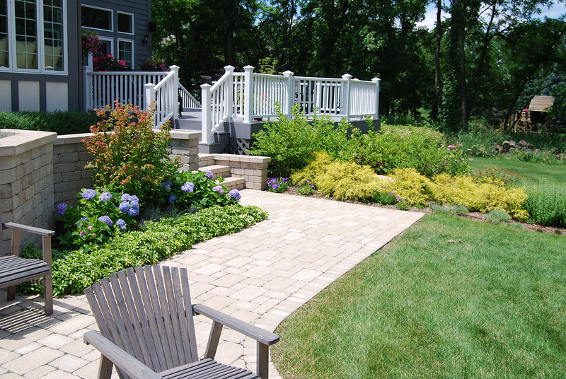 Backyard pathway made on brick surrounded by landscaping