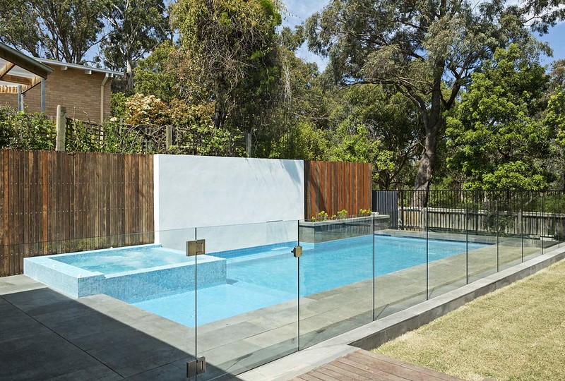 Glass fence surrounding an outdoor pool